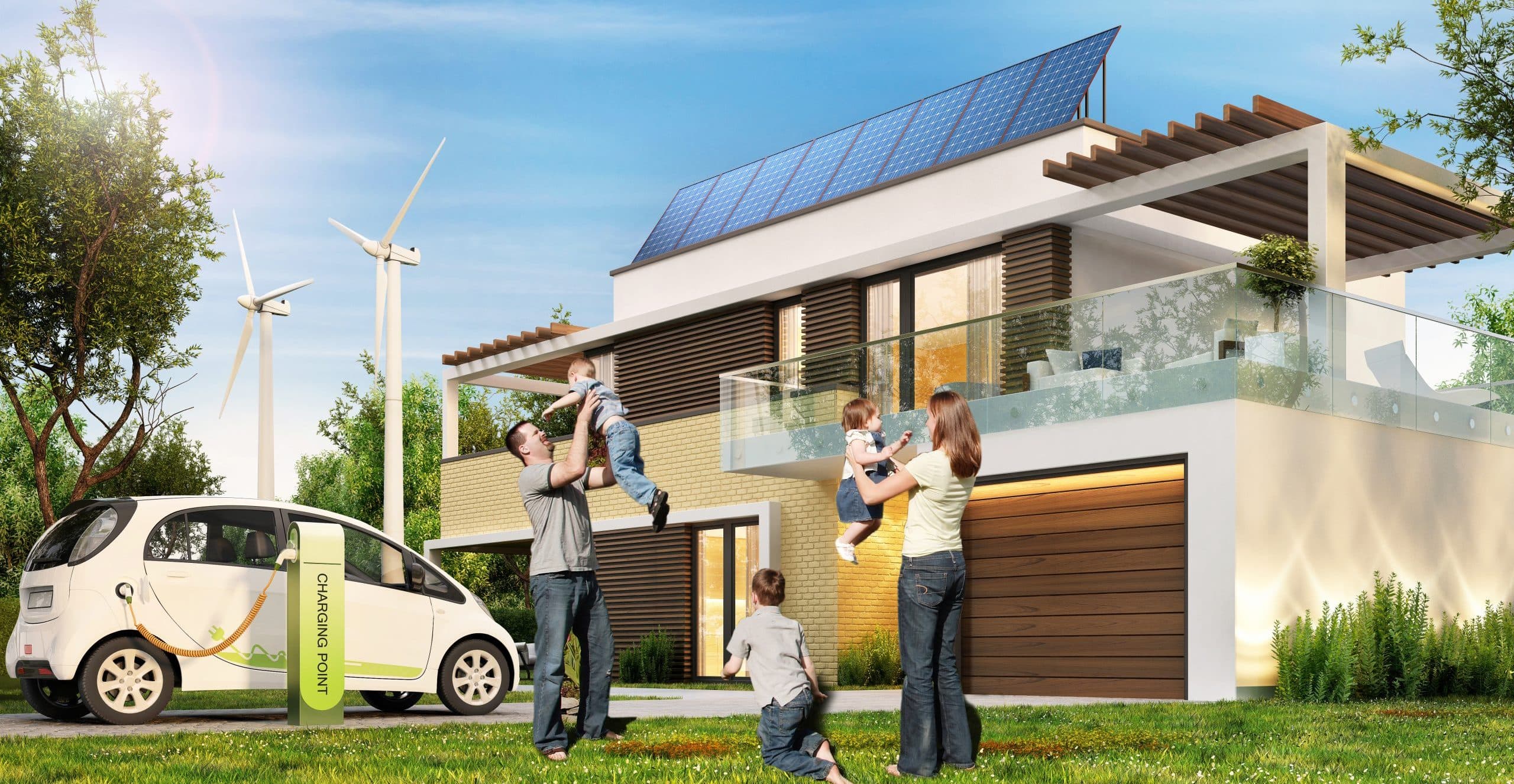 Eltern mit Kindern vor einem Haus mit PV-Anlage am Dach, Windrädern im Hintergrund und einem ladenden E-Auto.