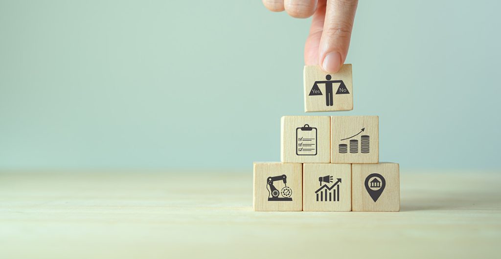 Wooden cubes with various prints, symbolic image for feasibility study